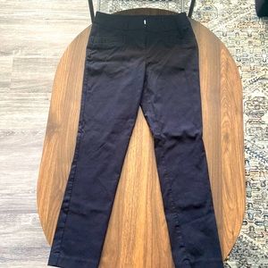 Black, skinny trousers with stretchy material, and clasp closing.